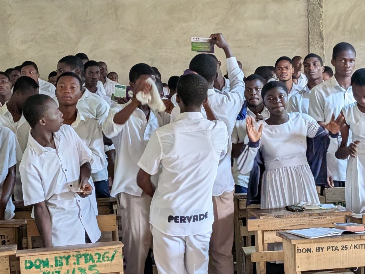 Students receiving Gospel literature during a school outreach